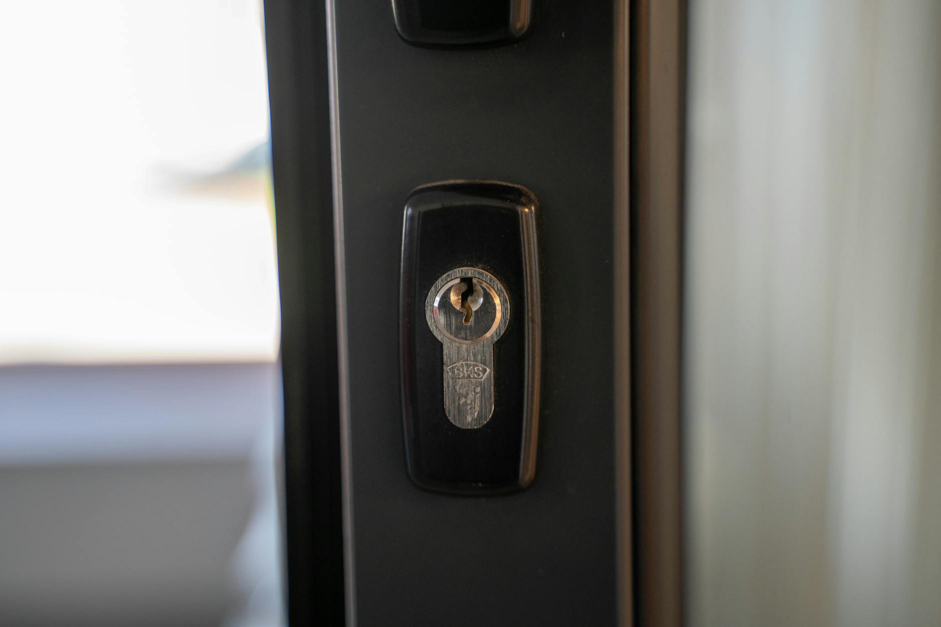 Detailed view of a steel keyhole on a door ensuring security and privacy.