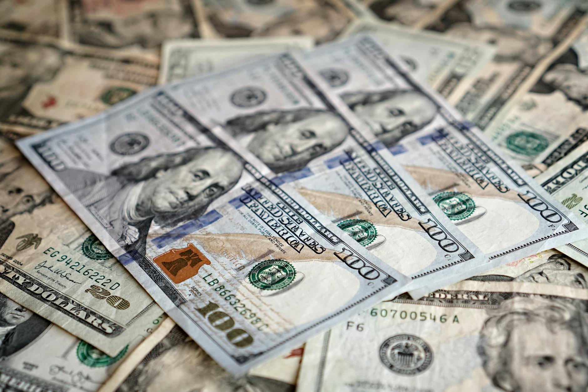 Detailed close-up of various denominations of US dollar bills, emphasizing currency and finance.
