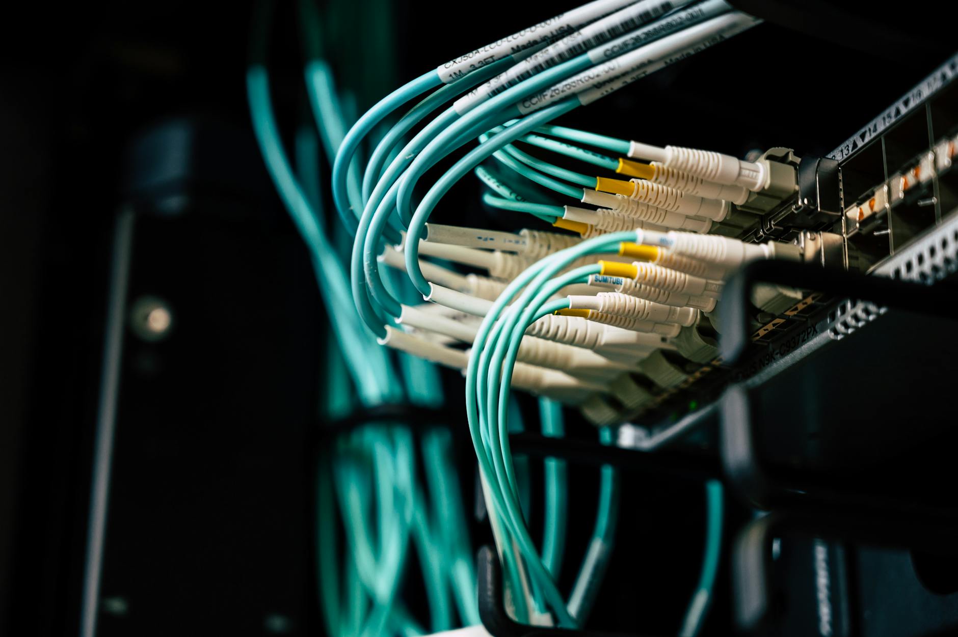 Server rack in a home office with cables and amber indicator LEDs